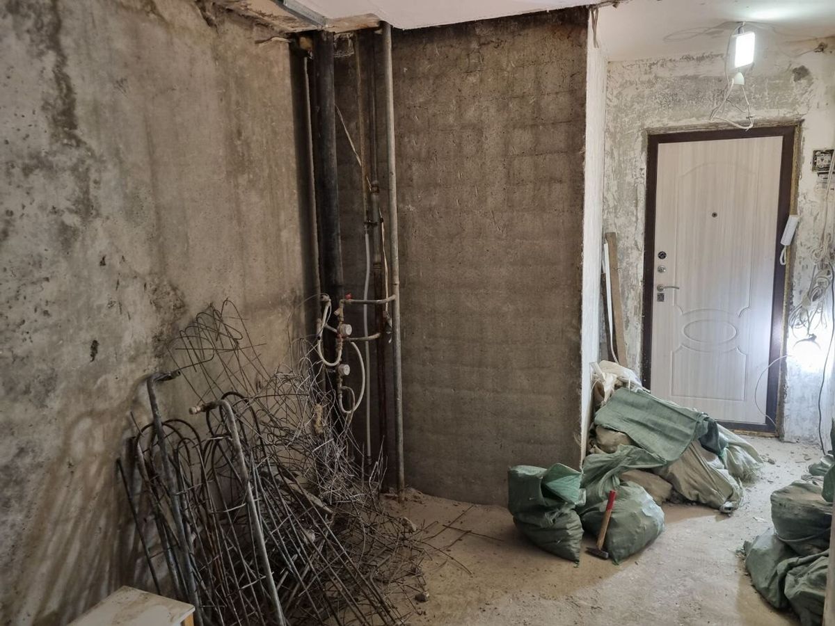 Byt vybouraný do betonu s pytli suti připravenými k odvozu, Praha